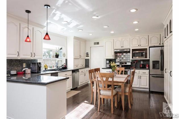 2664 Wheatfield Circle Simi Valley, CA 93063 - Photo 2 of 27 a kitchen that has a lot of white cabinets and stainless steel appliances