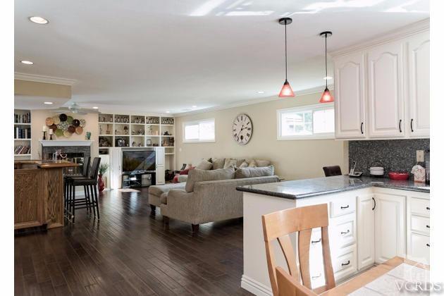 2664 Wheatfield Circle Simi Valley, CA 93063 - Photo 13 of 27 a open kitchen with stainless steel appliances granite countertop a stove and cabinets with wooden floor