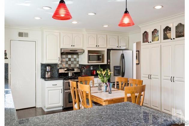 2664 Wheatfield Circle Simi Valley, CA 93063 - Photo 6 of 27 a kitchen with stainless steel appliances granite countertop a refrigerator and a stove top oven