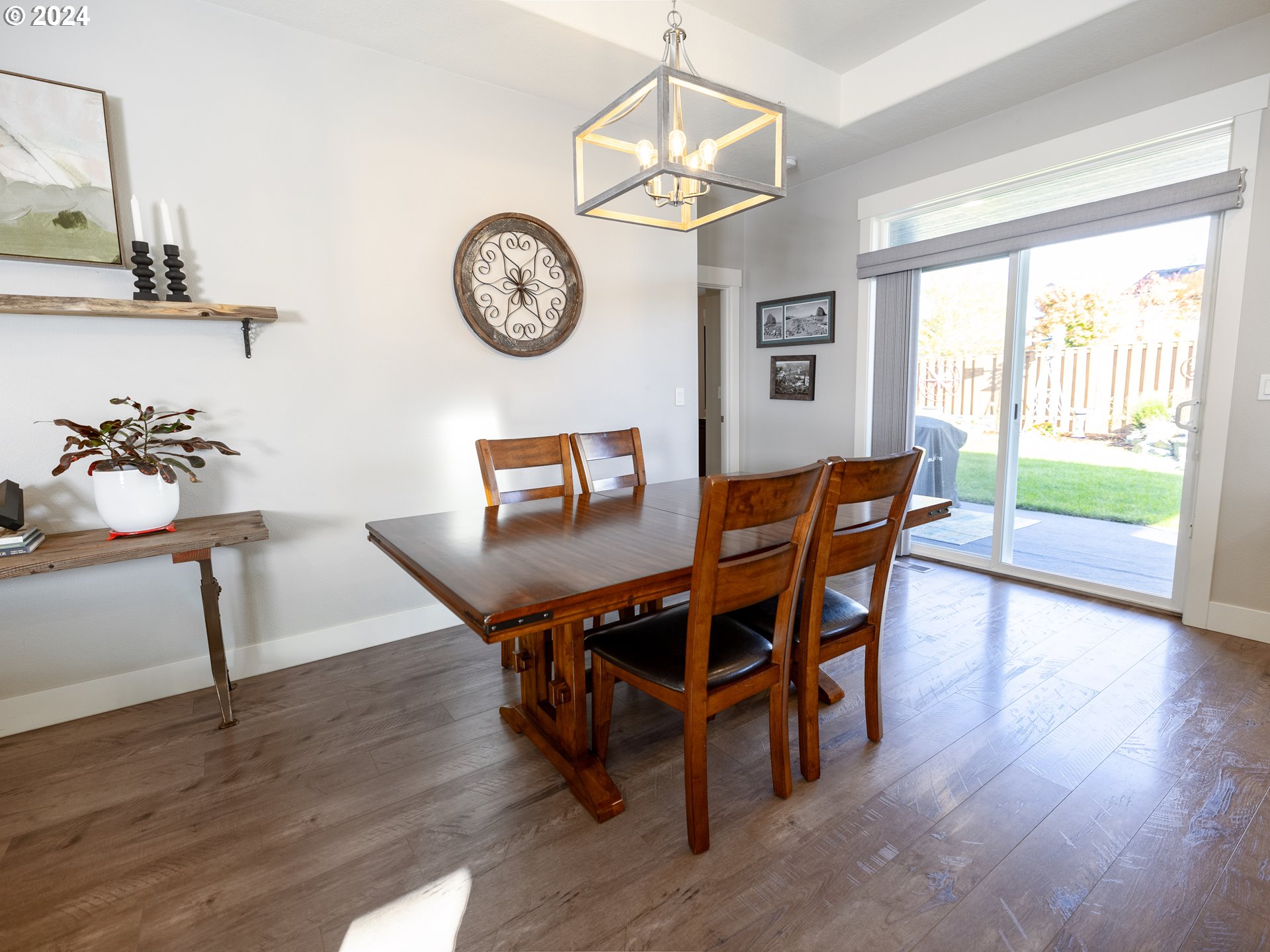 19390 Pine Avenue Sandy, OR 97055 - Photo 17 of 37 a dining room with wooden floor a chandelier a wooden table and chairs
