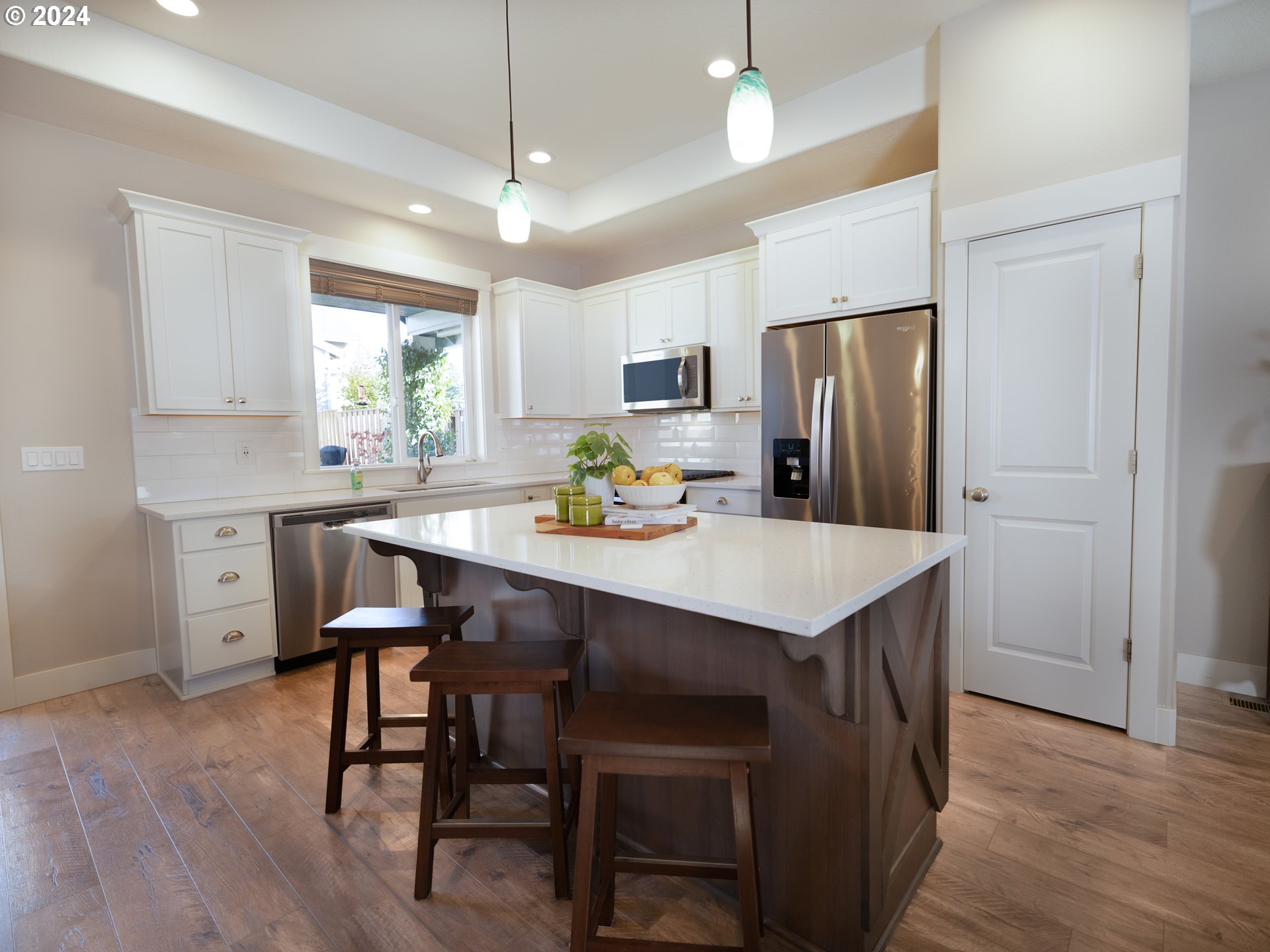 19390 Pine Avenue Sandy, OR 97055 - Photo 6 of 37 a kitchen with kitchen island a dining table and chairs