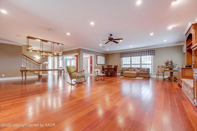 a living room with furniture a table and chair with wooden floor
