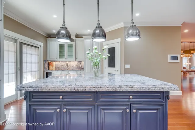 a kitchen with granite countertop wooden cabinets and white appliances