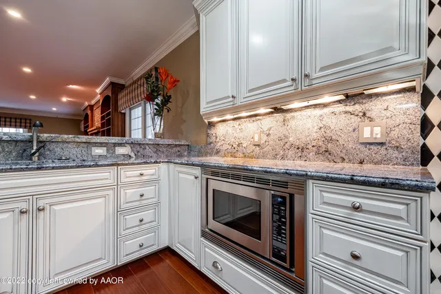 a dining room with furniture a chandelier and wooden floor