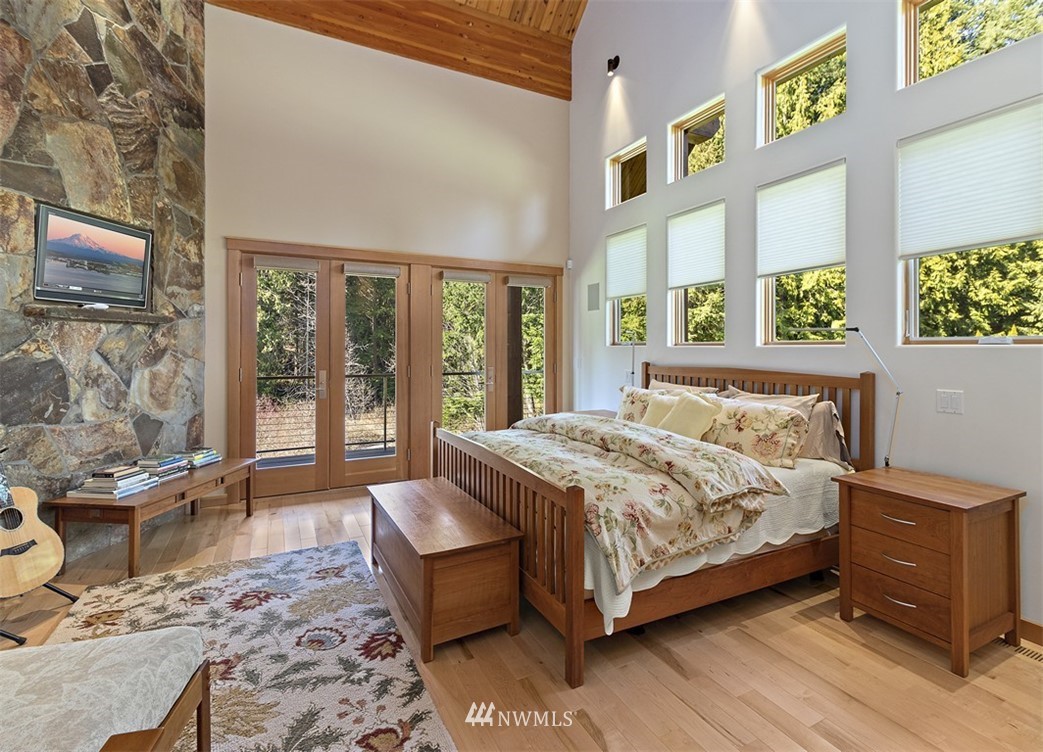 4731 Weber Road Snohomish, WA 98290 - Photo 22 of 40 a bedroom with a bed and large windows
