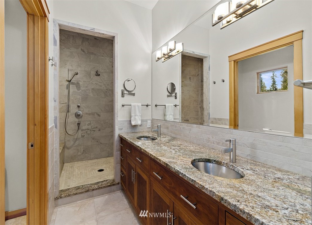 4731 Weber Road Snohomish, WA 98290 - Photo 24 of 40 a bathroom with a granite countertop sink mirror and shower