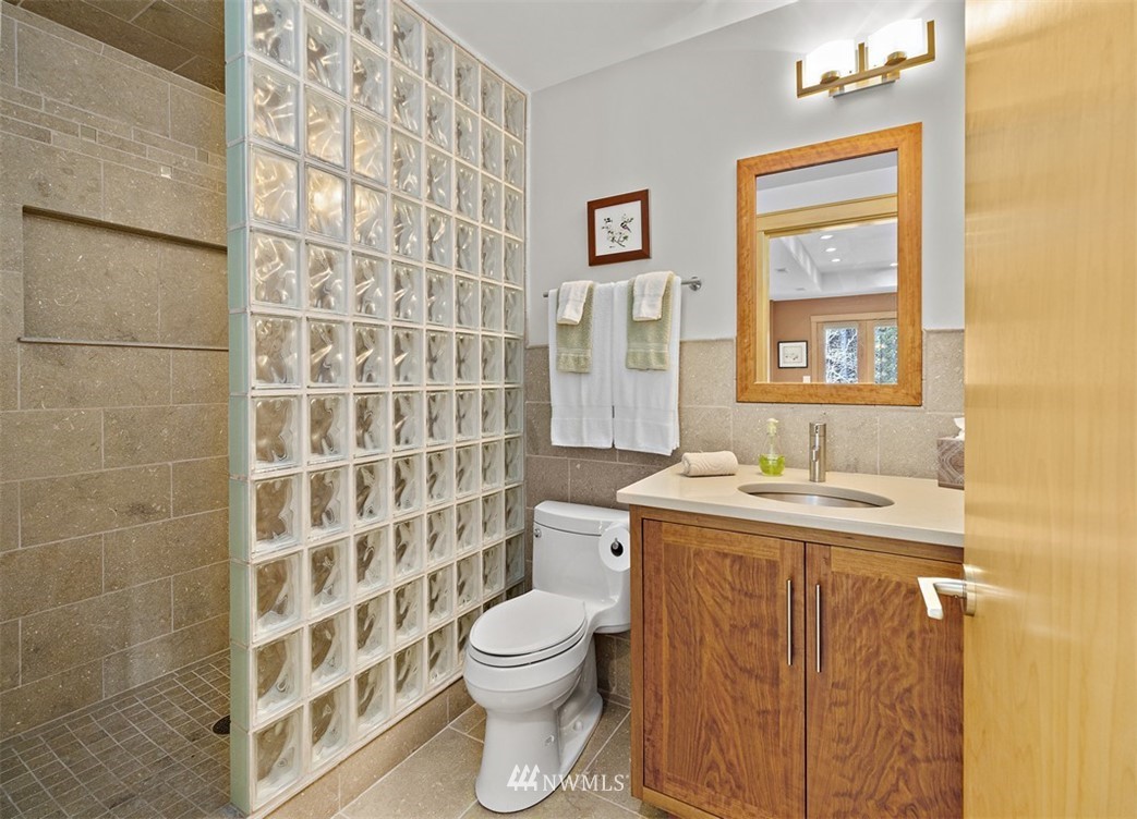 4731 Weber Road Snohomish, WA 98290 - Photo 29 of 40 a bathroom with a granite countertop toilet a sink and a shower