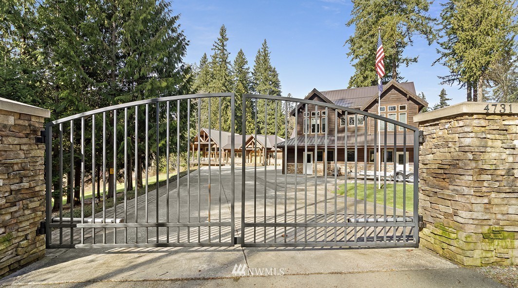 4731 Weber Road Snohomish, WA 98290 - Photo 40 of 40 a view of a brick house with a small yard and wooden fence