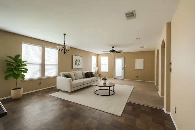 a living room with furniture and a large window
