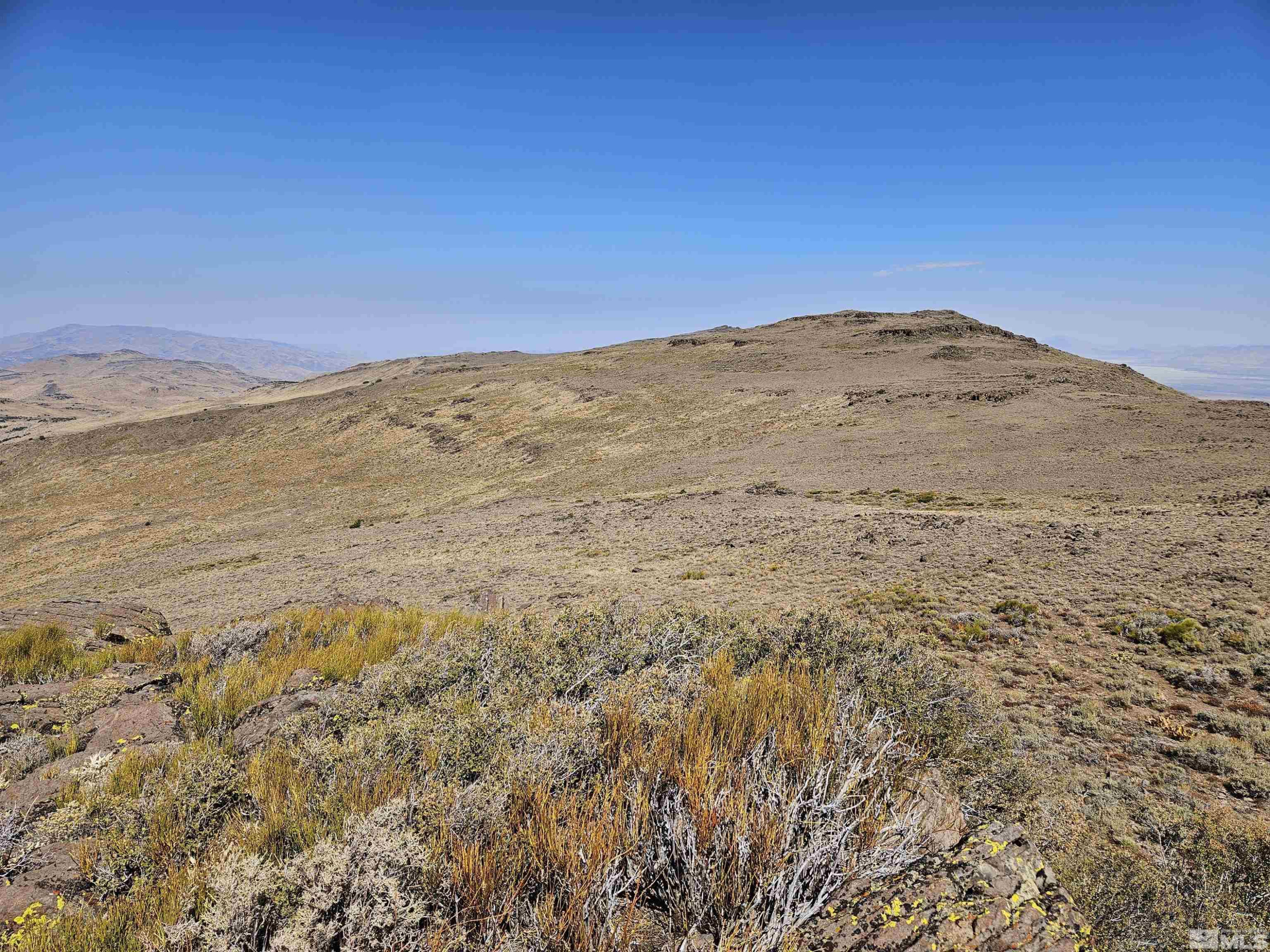 80 Rodero Road Reno, NV 89510 - Photo 4 of 12 a view of a large mountain with mountains in the background