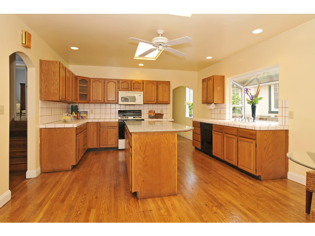 109 Bloomfield Road Burlingame, CA 94010 - Photo 3 of 15 a kitchen with stainless steel appliances kitchen island a cabinets and wooden floor