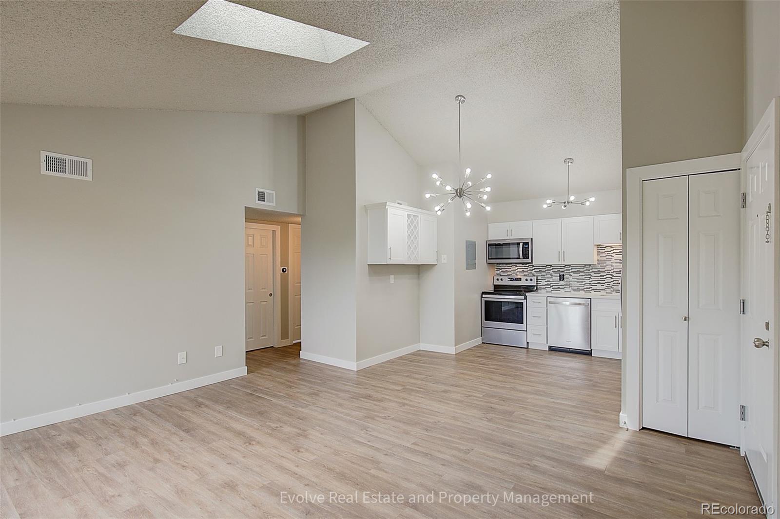 2575 South Syracuse Way, Unit J301 Denver, CO 80231 - Photo 5 of 14 a view of a kitchen with a sink and a refrigerator