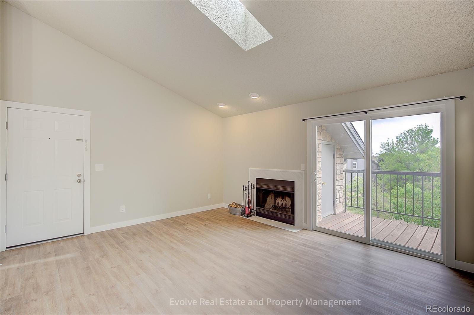 2575 South Syracuse Way, Unit J301 Denver, CO 80231 - Photo 7 of 14 a view of empty room with a fireplace