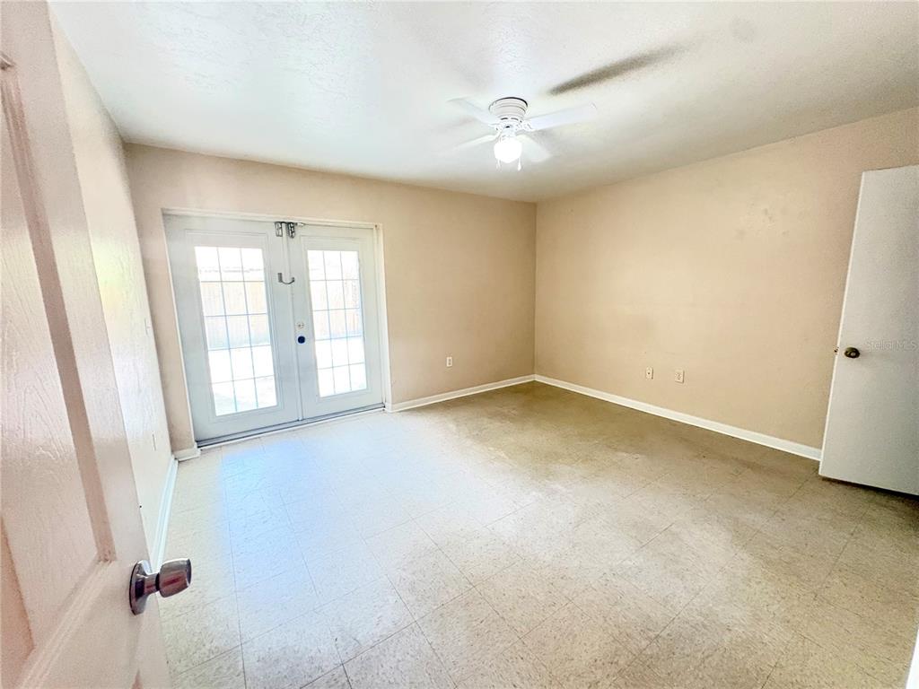 7011 Southwest 17th Place Gainesville, FL 32607 - Photo 17 of 22 an empty room with windows