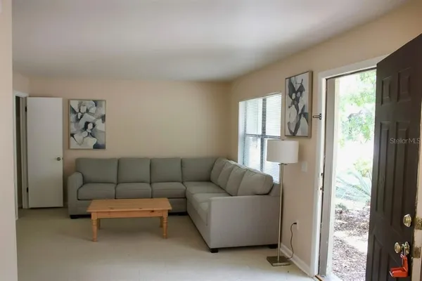a living room with furniture and a window