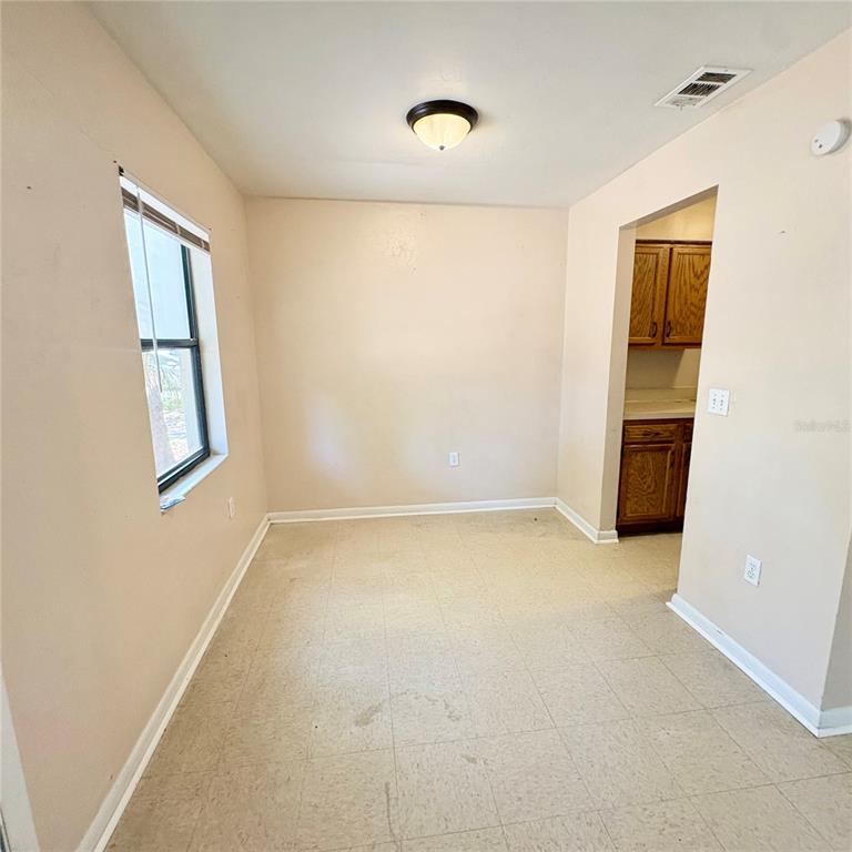 7011 Southwest 17th Place Gainesville, FL 32607 - Photo 4 of 22 a view of an empty room with a window