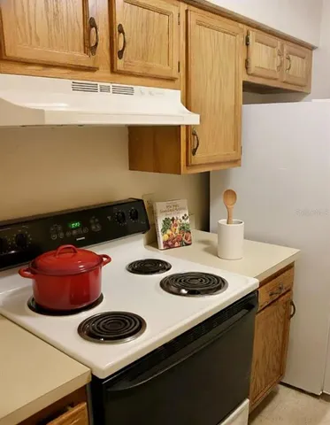 a kitchen with a sink and a white stove