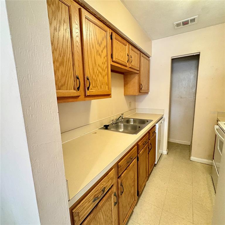7011 Southwest 17th Place Gainesville, FL 32607 - Photo 8 of 22 a kitchen with a sink and washing machine