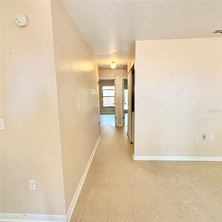 7011 Southwest 17th Place Gainesville, FL 32607 - Photo 10 of 22 a view of a hallway with wooden floor