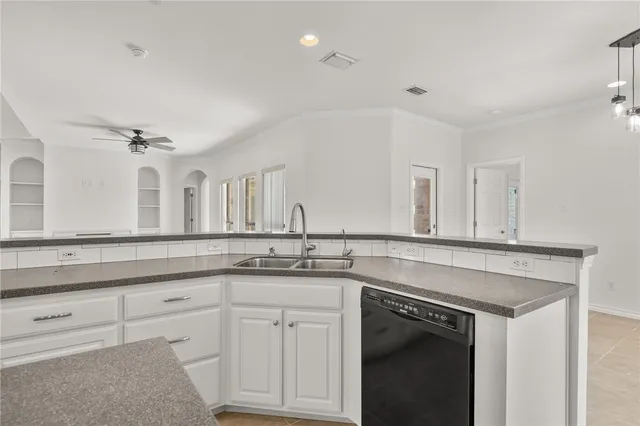 a kitchen with white cabinets and a sink