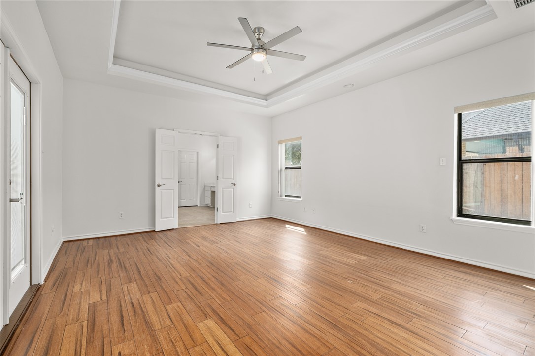 623 Broadway Boulevard Portland, TX 78374 - Photo 16 of 35 an empty room with wooden floor and windows