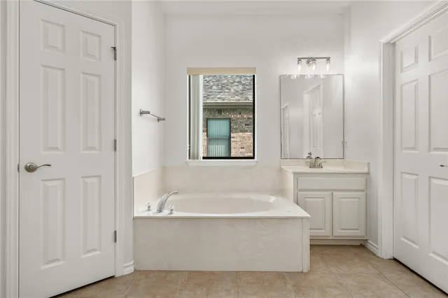 a spacious bathroom with bathtub and shower