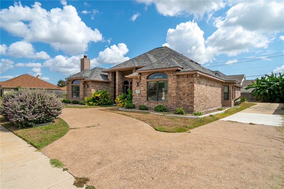 623 Broadway Boulevard Portland, TX 78374 - Photo 2 of 35 a front view of a house with a yard and garage