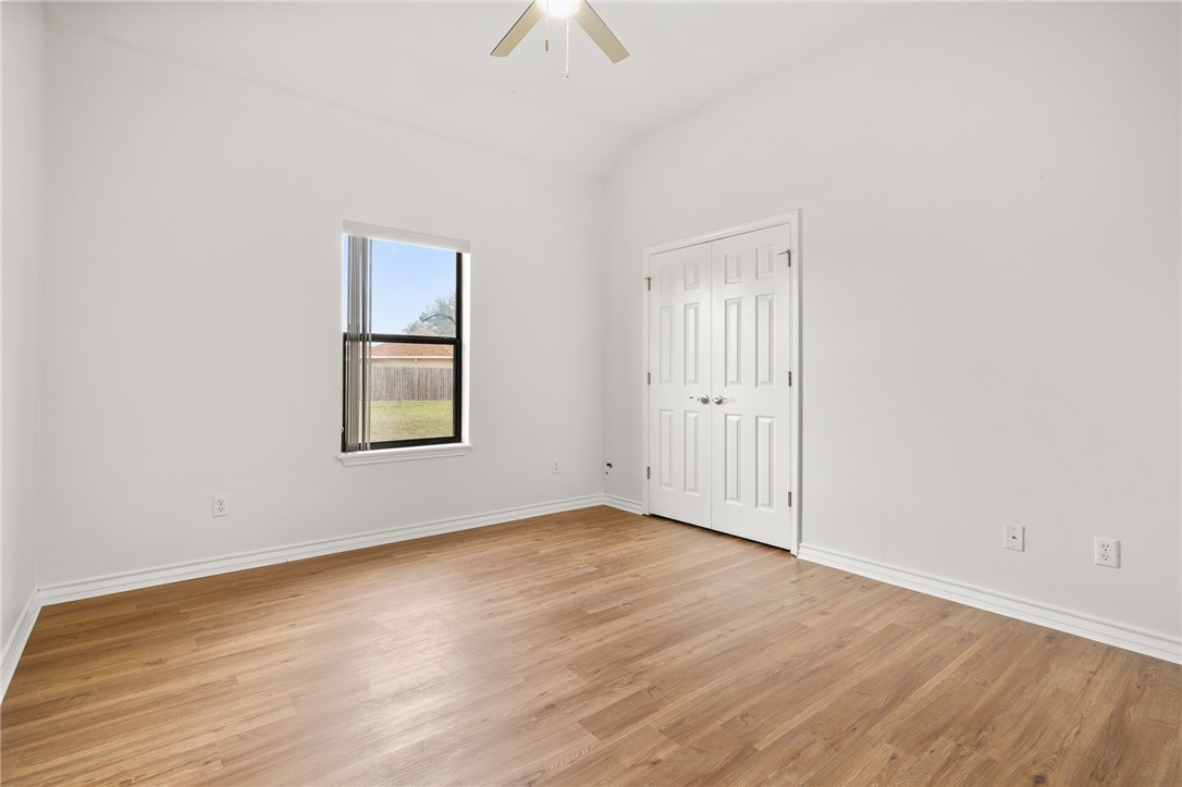 623 Broadway Boulevard Portland, TX 78374 - Photo 21 of 35 an empty room with wooden floor cabinet and windows