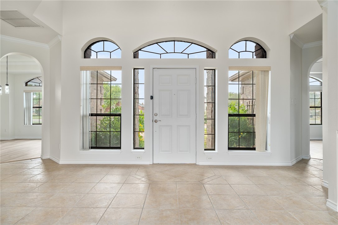 623 Broadway Boulevard Portland, TX 78374 - Photo 4 of 35 a view of an entryway with wooden floor and windows
