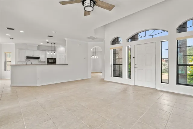 a view of a kitchen with stainless steel appliances granite countertop a refrigerator and a sink