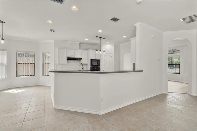 a view of kitchen with kitchen island and stainless steel appliances