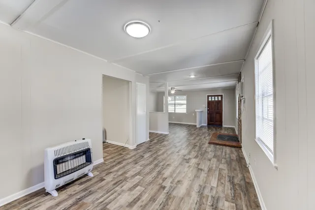 a view of hallway with wooden floor