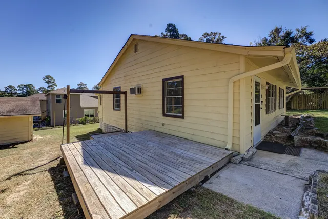 a view of a wooden deck front of house