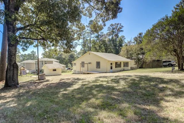 a white house that has a tree in front of it