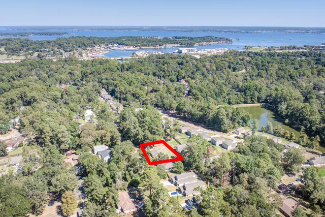 an aerial view of residential houses with outdoor space and trees