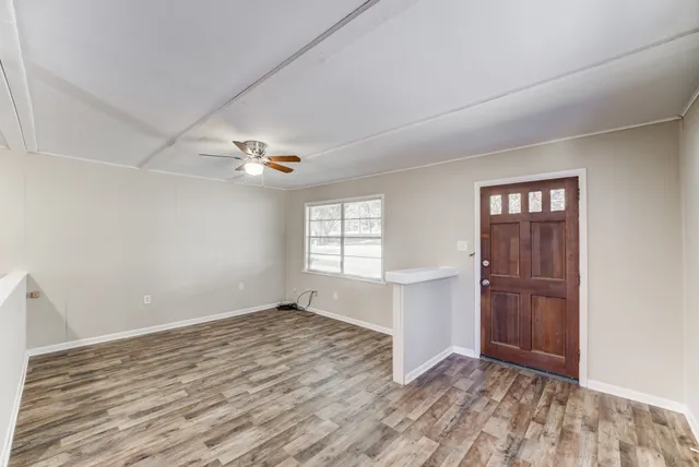 wooden floor in an empty room with a window