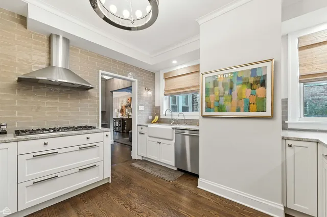 a kitchen with stainless steel appliances granite countertop a stove and cabinets