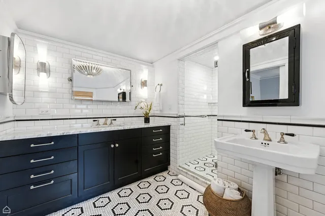 a bathroom with a double vanity sink mirror and