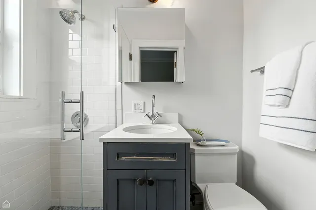 a bathroom with a toilet sink and mirror