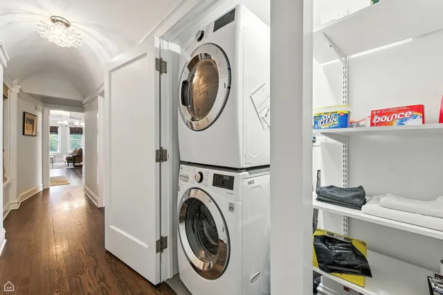 a utility room with dryer washer and a view of bedroom