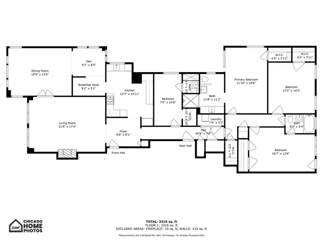 a picture of a kitchen with a refrigerator and white cabinets