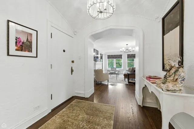 a living room with furniture and a chandelier