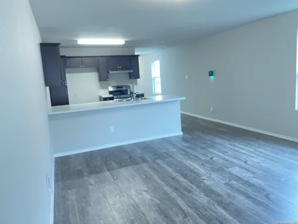 a view of kitchen with sink and wooden floor