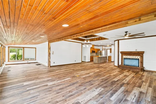 a view of a livingroom with wooden floor and a yard