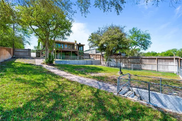 a view of a backyard with a garden and swimming pool