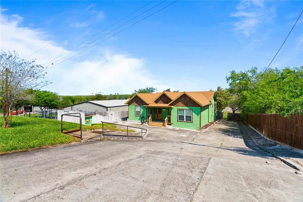 a view of houses with yard and trampoline