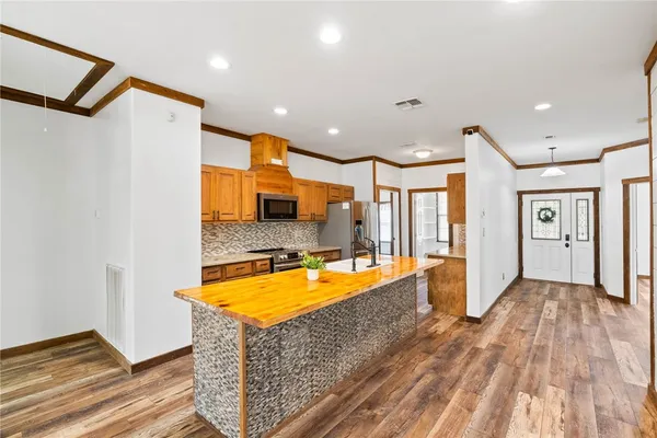 a very nice looking room with a large pool table and chairs