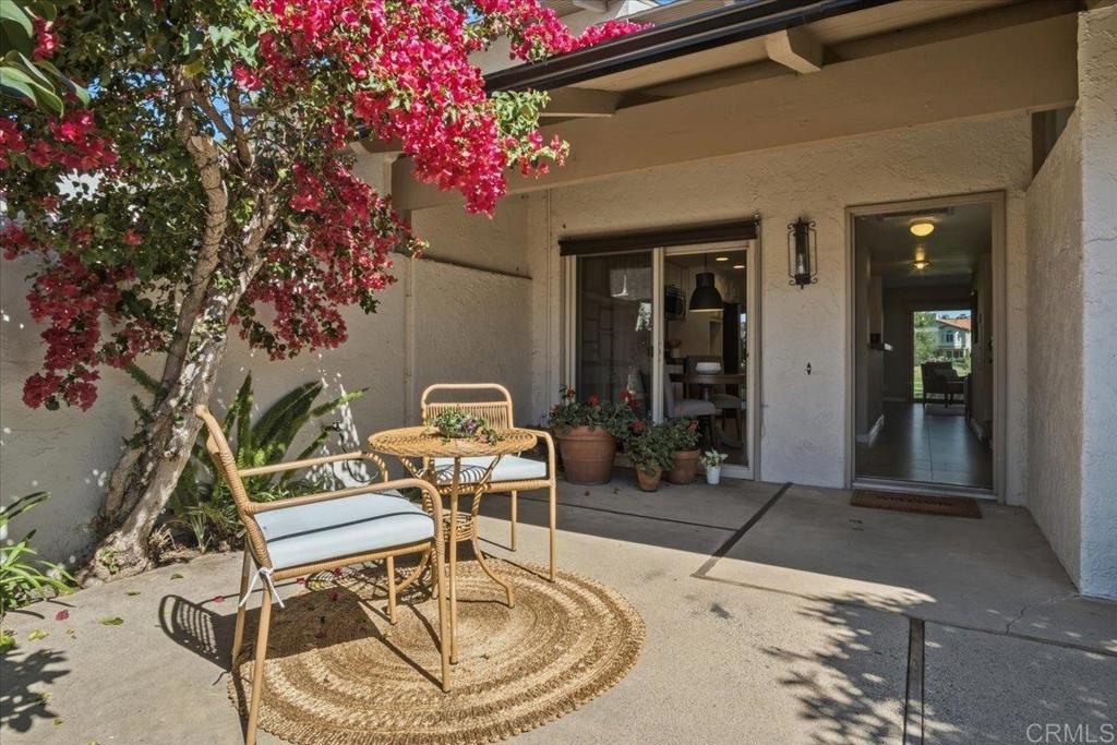 213 Via Osuna Rancho Santa Fe, CA 92091 - Photo 18 of 58 a patio with a table and chairs and potted plants