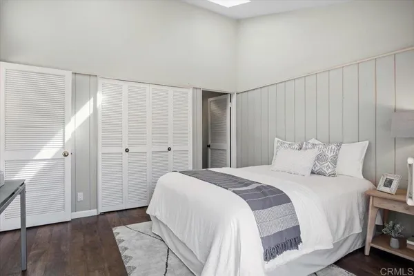 a spacious bedroom with a bed and a shower