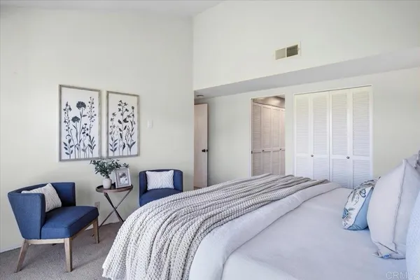 a bedroom with a bed and a chair